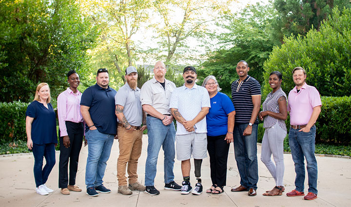 A group of wounded veterans and caregivers from the Warriors Speak team pose together